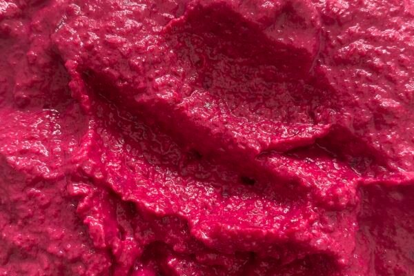 Hummus de remolacha de color rosa intenso en un bol.